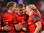 5 March 2022; Chris Farrell of Munster, right, celebrates with teammates Mike Haley, left, and Gavin Coombes after scoring their side's sixth try during the United Rugby Championship match between Munster and Dragons at Thomond Park in Limerick. Photo by Brendan Moran/Sportsfile