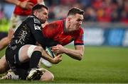 5 March 2022; Chris Farrell of Munster scores his side's sixth try despite the tackle of Josh Lewis of Dragons during the United Rugby Championship match between Munster and Dragons at Thomond Park in Limerick. Photo by Brendan Moran/Sportsfile