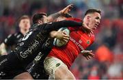 5 March 2022; Chris Farrell of Munster scores his side's sixth try despite the tackle of Josh Lewis of Dragons during the United Rugby Championship match between Munster and Dragons at Thomond Park in Limerick. Photo by Brendan Moran/Sportsfile