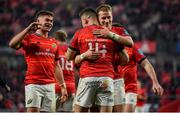5 March 2022; Shane Daly of Munster, right, celebrates with teammates Jack Crowley and Mike Haley after scoring their side's seventh try during the United Rugby Championship match between Munster and Dragons at Thomond Park in Limerick. Photo by Brendan Moran/Sportsfile