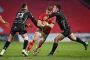 5 March 2022; Jack Crowley of Munster is tackled by Josh Lewis, left, and Sam Davies of Dragons during the United Rugby Championship match between Munster and Dragons at Thomond Park in Limerick. Photo by Brendan Moran/Sportsfile