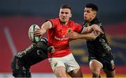 5 March 2022; Shane Daly of Munster offloads the ball while being tackled by Jordan Williams, left, and Rio Dyer of Dragons during the United Rugby Championship match between Munster and Dragons at Thomond Park in Limerick. Photo by Brendan Moran/Sportsfile