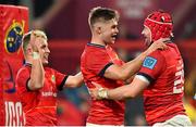 5 March 2022; John Hodnett of Munster, right, celebrates with teammates Jack Crowley and Craig Casey, left, after scoring their side's ninth try during the United Rugby Championship match between Munster and Dragons at Thomond Park in Limerick. Photo by Brendan Moran/Sportsfile