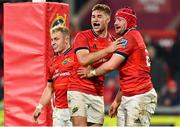5 March 2022; John Hodnett of Munster, right, celebrates with teammates Jack Crowley and Craig Casey, left, after scoring their side's ninth try during the United Rugby Championship match between Munster and Dragons at Thomond Park in Limerick. Photo by Brendan Moran/Sportsfile