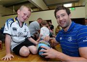 31 July 2013; Leinster's Kevin McLaughlin signs a ball for Cayden Hanley, age 6, from the Curragh Camp, during a Leinster Rugby Summer Camp at Cill Dara RFC, Kildare, Co. Kildare. Picture credit: David Maher / SPORTSFILE
