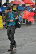 31 July 2013; Racegoer Darragh Allen, from Ardan, Co. Cork, struggles with his umbrella during a day at the races. Galway Racing Festival, Ballybrit, Co. Galway. Picture credit: Barry Cregg / SPORTSFILE