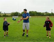 31 July 2013; Leinster's Kevin McLaughlin in action with Ronan Leary, left, age 9, and Pearse McCarthy, age 10, both from the Curragh Camp, during a Leinster Rugby Summer Camp at Cill Dara RFC, Kildare, Co. Kildare. Picture credit: David Maher / SPORTSFILE