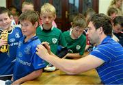 31 July 2013; Leinster's Kevin McLaughlin signs the jersey of Ciaran O'Gorman, age 10, from the Curragh Camp, during a Leinster Rugby Summer Camp at Cill Dara RFC, Kildare, Co. Kildare. Picture credit: David Maher / SPORTSFILE