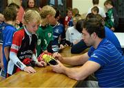 31 July 2013; Leinster's Kevin McLaughlin signs a pair of boots for Pearse McCarthy, age 10, from the Curragh Camp, during a Leinster Rugby Summer Camp at Cill Dara RFC, Kildare, Co. Kildare. Picture credit: David Maher / SPORTSFILE