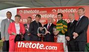 31 July 2013; The President of Ireland Michael D. Higgins presents winning owner J.P. McManus with the Galway Plate, alongside jockey Tony McCoy and winning connections, after victory in the www.thetote.com Galway Plate with Carlingford Lough. Galway Racing Festival, Ballybrit, Co. Galway. Picture credit: Barry Cregg / SPORTSFILE