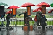 1 August 2013; Bookmakers take shelter under their umberellas ahead of the day's races. Galway Racing Festival, Ballybrit, Co. Galway. Picture credit: Barry Cregg / SPORTSFILE