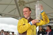 1 August 2013; Jockey Robbie Power lifts the trophy after he rode Missunited to victory in the Guinness Galway Hurdle Handicap. Galway Racing Festival, Ballybrit, Co. Galway.