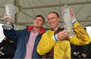 1 August 2013; Jockey Robbie Power and trainer Michael Winters lift up their trophies after victory in the Guinness Galway Hurdle Handicap with Missunited. Galway Racing Festival, Ballybrit, Co. Galway.