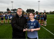 8 March 2022; LGFA member Con Moynihan presents the player of the match award to Bronagh Quinn of GMIT Mayo after the Yoplait LGFA Higher Education Football Championships Final match between GMIT Mayo and University of Ulster, Antrim, at DCU Dóchas Éireann Astro Pitch in Dublin. Photo by David Fitzgerald/Sportsfile