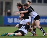 8 March 2022; Michael Carmody of Belvedere College is tackled by Denis Downing, left, and Tom Waters of Newbridge College during the Bank of Ireland Leinster Rugby Schools Senior Cup 2nd Round match between Newbridge College and Belvedere College at Energia Park in Dublin. Photo by Sam Barnes/Sportsfile