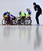 12 March 2022; Players contest possession as referee Maggie Farrelly keeps watch during the GAA National Wheelchair Hurling/Camogie Interprovincial leagues match between Munster and Connacht at Omagh Leisure Centre in Omagh, Tyrone. Photo by Ben McShane/Sportsfile