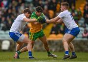 13 March 2022; Ódhran McFadden Ferry of Donegal is tackled by Darren Hughes, left, and Mícheal Bannigan of Monaghan during the Allianz Football League Division 1 match between Donegal and Monaghan at MacCumhaill Park in Ballybofey, Donegal. Photo by Ramsey Cardy/Sportsfile