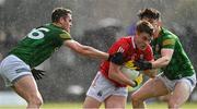 13 March 2022; Fionn Herlihy of Cork in action against Brian Menton, left, and Eoin Harkin of Meath during the Allianz Football League Division 2 match between Meath and Cork at Páirc Táilteann in Navan, Meath. Photo by Brendan Moran/Sportsfile