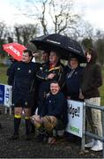 13 March 2022; Clondalkin substitutes shelter under an umbrella during the Bank of Ireland Leinster Rugby Provincial Towns Cup 2nd Round match between Newbridge RFC and Clondalkin RFC at Newbridge RFC in Newbridge, Kildare. Photo by Harry Murphy/Sportsfile