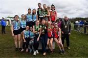 12 March 2022; On the podium after the senior girls race, are, Loreto Kilkenny, Down High School, Downpatrick, and Pobalscoil na Trionoide, Cork, during the Irish Life Health All-Ireland Schools Cross Country at the City of Belfast Mallusk Playing Fields in Belfast. Photo by Ramsey Cardy/Sportsfile