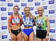 27 February 2022; Senior women's 60m medallists, Molly Scott of St Laurence O'Toole AC, Carlow, gold, Lauren Roy of City of Lisburn AC, Down, silver and Sarah Leahy of Killarney Valley AC, Kerry, bronze, during day two of the Irish Life Health National Senior Indoor Athletics Championships at the National Indoor Arena at the Sport Ireland Campus in Dublin. Photo by Sam Barnes/Sportsfile