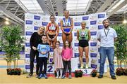 27 February 2022; Senior women's 60m medallists, Molly Scott of St Laurence O'Toole AC, Carlow, gold, Lauren Roy of City of Lisburn AC, Down, silver and Sarah Leahy of Killarney Valley AC, Kerry, bronze, pictured alongside, from left, Olympian Derval O'Rourke, Cian McGrath, Aoibh McGrath, Dafne O'Leary, and Athletics Ireland Chair of Competition Andrew Lynam during day two of the Irish Life Health National Senior Indoor Athletics Championships at the National Indoor Arena at the Sport Ireland Campus in Dublin. Photo by Sam Barnes/Sportsfile