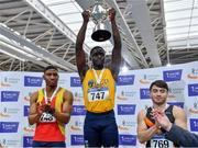 27 February 2022; Israel Olatunde of UCD AC, Dublin, lifts the Craig Lynch cup after winning the senior men's 60m during day two of the Irish Life Health National Senior Indoor Athletics Championships at the National Indoor Arena at the Sport Ireland Campus in Dublin. Photo by Sam Barnes/Sportsfile