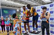 27 February 2022; Israel Olatunde of UCD AC, Dublin is presented with the Craig Lynch cup after winning the senior men's 60m during day two of the Irish Life Health National Senior Indoor Athletics Championships at the National Indoor Arena at the Sport Ireland Campus in Dublin. Photo by Sam Barnes/Sportsfile