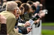 15 March 2022; Racegoers study the form before racing on day one of the Cheltenham Racing Festival at Prestbury Park in Cheltenham, England. Photo by Seb Daly/Sportsfile
