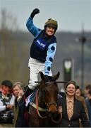 15 March 2022; Jockey Tom Cannon, on Edwardstone, celebrates after winning the Sporting Life Arkle Challenge Trophy Novices' Chase, as they are lead into the parade ring by groom Caroline Schofield, during day one of the Cheltenham Racing Festival at Prestbury Park in Cheltenham, England. Photo by Seb Daly/Sportsfile