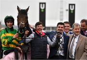 15 March 2022; Jockey Mark Walsh, left, groom Ian Queally, centre, and owner JP McManus celebrate winning the Boodles Juvenile Handicap Hurdle with Brazil during day one of the Cheltenham Racing Festival at Prestbury Park in Cheltenham, England. Photo by Seb Daly/Sportsfile