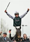 16 March 2022; Jockey Charlie Deutsch celebrates after riding L'Homme Presse to victory in the Brown Advisory Novices' Chase, as they are lead into the winners enclosure by groom Beth Baldwin and owner Peter Pink, on day two of the Cheltenham Racing Festival at Prestbury Park in Cheltenham, England. Photo by David Fitzgerald/Sportsfile