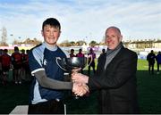 16 March 2022; Callum Beasley of Ardgillan Community College is presented with the cup by Pat Rossiter after the Pat Rossiter Cup Final match between St Mary’s CBS Portlaoise, Laois and Ardgillan Community College, Dublin at Energia Park in Dublin. Photo by Eóin Noonan/Sportsfile