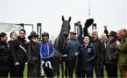 16 March 2022; Energumene, jockey Paul Townend, with girlfriend Anna Paoletti, groom Imran Haider, trainer Willie Mullins, owner Tony Bloom and winning connections celebrate after winning the Betway Queen Mother Champion Chase on day two of the Cheltenham Racing Festival at Prestbury Park in Cheltenham, England. Photo by David Fitzgerald/Sportsfile