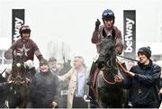 16 March 2022; Race winner Delta Work, with Jack Kennedy up, and Tiger Roll, with Davy Russell up, left, are lead into the winners enclosure after the Glenfarclas Cross Country Chase on day two of the Cheltenham Racing Festival at Prestbury Park in Cheltenham, England. Photo by David Fitzgerald/Sportsfile
