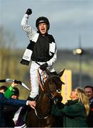 17 March 2022; Jockey Danny Mullins celebrates after riding Flooring Porter to win the Paddy Power Stayers' Hurdle, as groom Caragh Monaghan leads them into the winner's enclosure on day three of the Cheltenham Racing Festival at Prestbury Park in Cheltenham, England. Photo by Seb Daly/Sportsfile