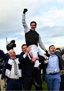 17 March 2022; Jockey Danny Mullins is lifted in celebration by winning connections of Flooring Porter, including Kerril Creaven, left, and James Skehill after winning the Paddy Power Stayers' Hurdle on day three of the Cheltenham Racing Festival at Prestbury Park in Cheltenham, England. Photo by Seb Daly/Sportsfile