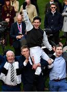 17 March 2022; Jockey Danny Mullins is lifted in celebration by winning connections of Flooring Porter, including Kerril Creaven, left, and James Skehill, second from left, after winning the Paddy Power Stayers' Hurdle on day three of the Cheltenham Racing Festival at Prestbury Park in Cheltenham, England. Photo by David Fitzgerald/Sportsfile