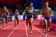 18 March 2022; Phil Healy of Ireland, centre, crosses the line to win her heat in the women's 400m, ahead of Lieke Klaver of Netherlands, right, who finished second,  during day one of the World Indoor Athletics Championships at the Štark Arena in Belgrade, Serbia. Photo by Sam Barnes/Sportsfile