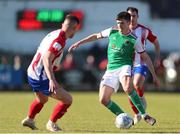 18 March 2022; Ronan Hurley of Cork City in action against Charlie Fleming of Treaty United during the SSE Airtricity League First Division match between Treaty United and Cork City at Markets Field in Limerick. Photo by Michael P Ryan/Sportsfile