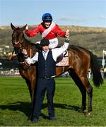 18 March 2022; Rachael Blackmore aboard A Plus Tard, and groom John Ferguson celebrate after winning the Boodles Cheltenham Gold Cup Chase during day four of the Cheltenham Racing Festival at Prestbury Park in Cheltenham, England. Photo by Seb Daly/Sportsfile Photo by Seb Daly/Sportsfile