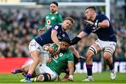 19 March 2022; Bundee Aki of Ireland is tackled by Chris Harris of Scotland during the Guinness Six Nations Rugby Championship match between Ireland and Scotland at Aviva Stadium in Dublin. Photo by Ramsey Cardy/Sportsfile