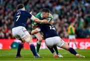 19 March 2022; Jonathan Sexton of Ireland is tackled by Sam Johnson, right, and Hamish Watson of Scotland during the Guinness Six Nations Rugby Championship match between Ireland and Scotland at Aviva Stadium in Dublin. Photo by Brendan Moran/Sportsfile
