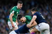 19 March 2022; James Lowe of Ireland is tackled by Hamish Watson and Sam Johnson of Scotland during the Guinness Six Nations Rugby Championship match between Ireland and Scotland at Aviva Stadium in Dublin. Photo by Brendan Moran/Sportsfile
