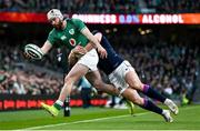 19 March 2022; Mack Hansen of Ireland is tackled by Kyle Steyn of Scotland during the Guinness Six Nations Rugby Championship match between Ireland and Scotland at the Aviva Stadium in Dublin. Photo by Harry Murphy/Sportsfile