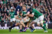 19 March 2022; Garry Ringrose of Ireland, supported by teammate Caelan Doris, right, is tackled by Rory Darge of Scotland during the Guinness Six Nations Rugby Championship match between Ireland and Scotland at Aviva Stadium in Dublin. Photo by Brendan Moran/Sportsfile