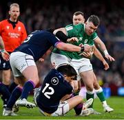 19 March 2022; Peter O’Mahony of Ireland is tackled by Zander Fagerson, 3, and Sam Johnson of Scotland during the Guinness Six Nations Rugby Championship match between Ireland and Scotland at Aviva Stadium in Dublin. Photo by Brendan Moran/Sportsfile