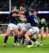 19 March 2022; James Lowe of Ireland is tackled by Stuart Hogg, left, and Darcy Graham of Scotland during the Guinness Six Nations Rugby Championship match between Ireland and Scotland at Aviva Stadium in Dublin. Photo by Brendan Moran/Sportsfile