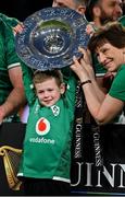 19 March 2022; Luca Sexton, son of Jonathan Sexton of Ireland, lifts the Triple Crown trophy with Ireland team performance nutritionist Ruth Wood Martin, right, after the Guinness Six Nations Rugby Championship match between Ireland and Scotland at Aviva Stadium in Dublin. Photo by Brendan Moran/Sportsfile