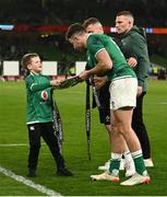19 March 2022; Luca Sexton, son of Ireland captain Jonathan Sexton, gives The Triple Crown trophy to Hugo Keenan of Ireland after the Guinness Six Nations Rugby Championship match between Ireland and Scotland at Aviva Stadium in Dublin. Photo by Harry Murphy/Sportsfile